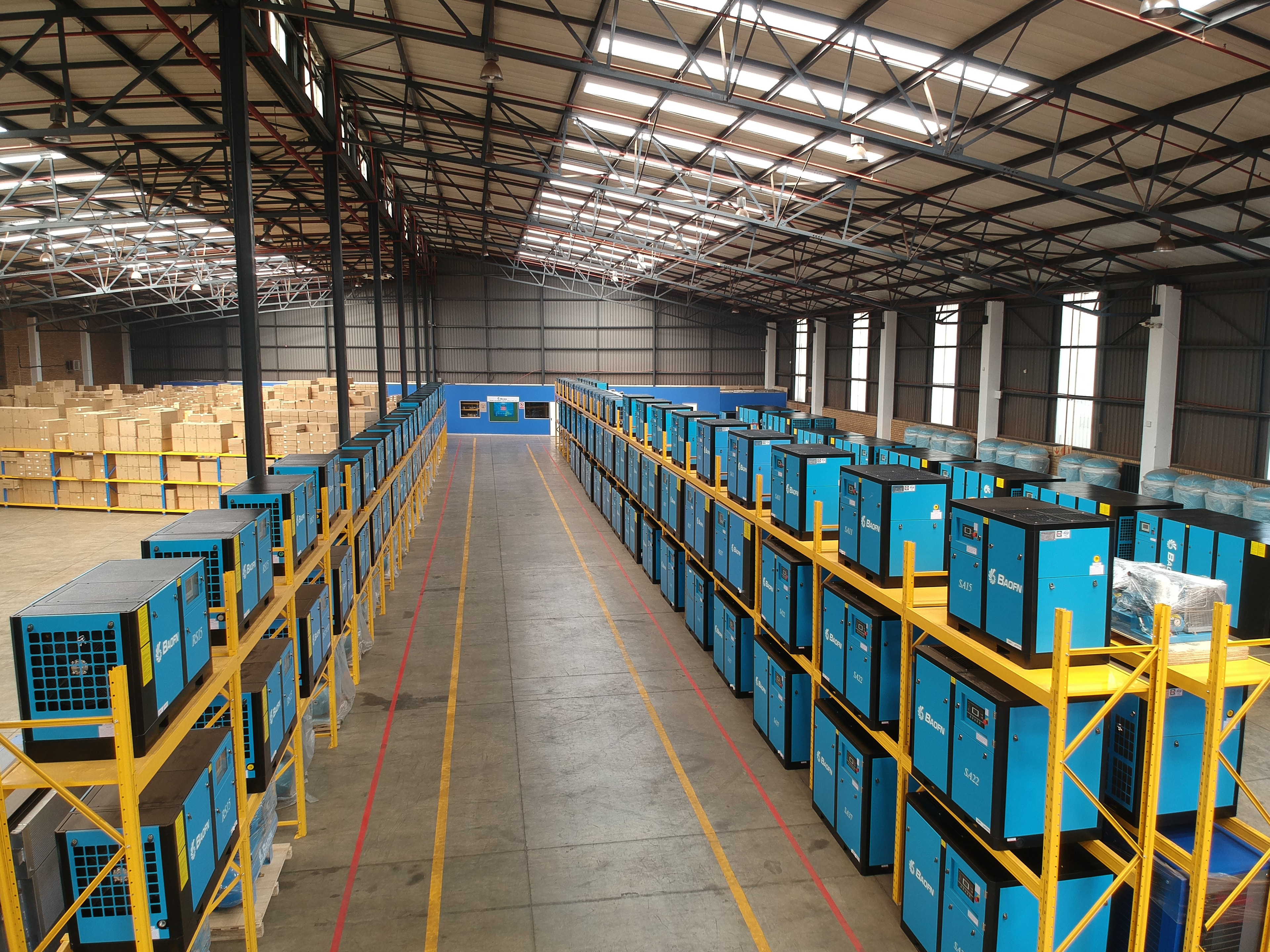 Warehouse aisle of BAOFN spare parts on yellow-and-blue racking